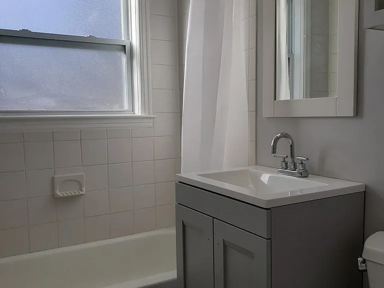 Brand new bathroom with new vanity, tub, and toilet.