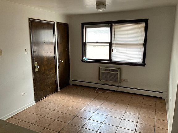 kitchen with door to back exit and corner pantry.