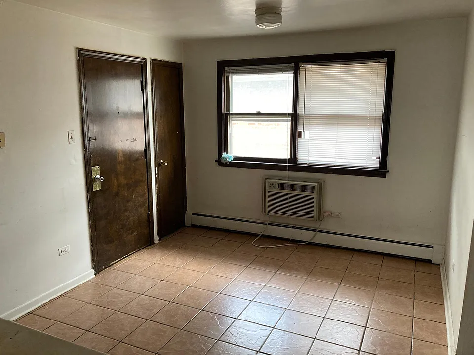 kitchen with door to back exit and corner pantry.