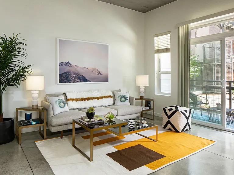 Apartment living room with polished concrete flooring.