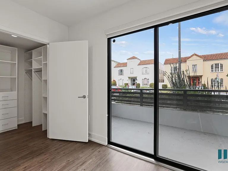 Bedroom with Walk-In Closet and Balcony Access