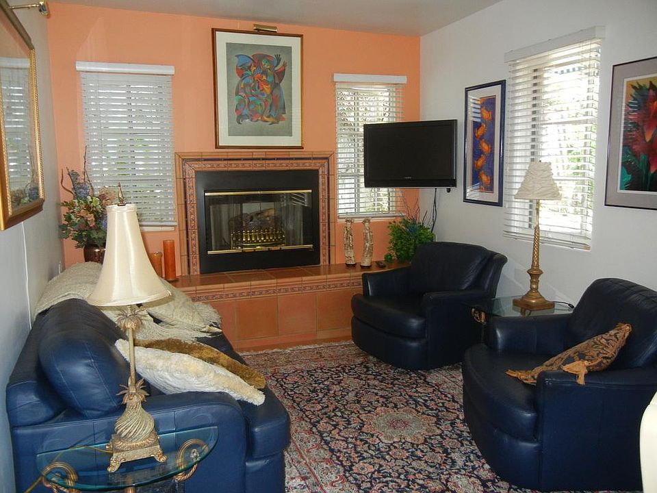 Living Room with gas fireplace, leather furniture, Flat screen TV Kashan rug