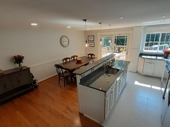 The upstairs features newly finished hardwoods (2022), and recently updated recessed lighting throughout (2021). The dining area walks out onto the large back deck, overlooking the yard.