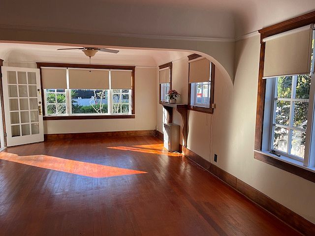 Living and dining room with hardwood floors and gas heater.