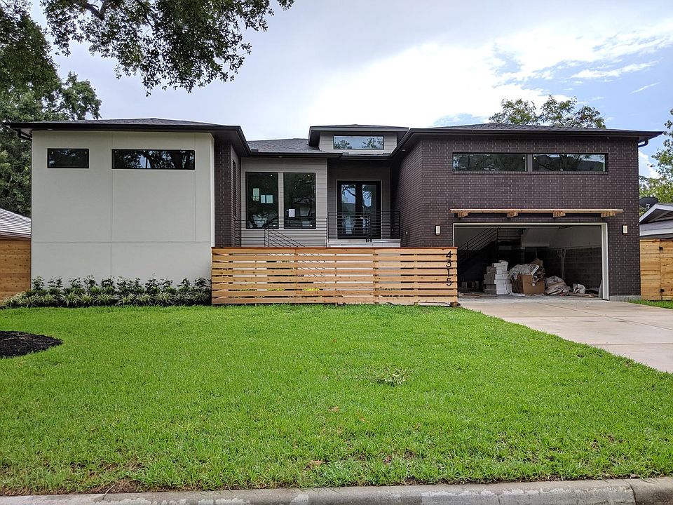 Simply Modern front elevation with combination of stucco, brick, and hardiplank siding. Low maintenance yard with preset sprinkler system