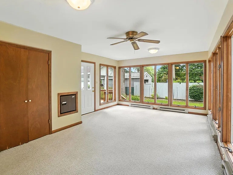 Four Season Sunroom with the door to the deck. There is a wet bar in the closet.