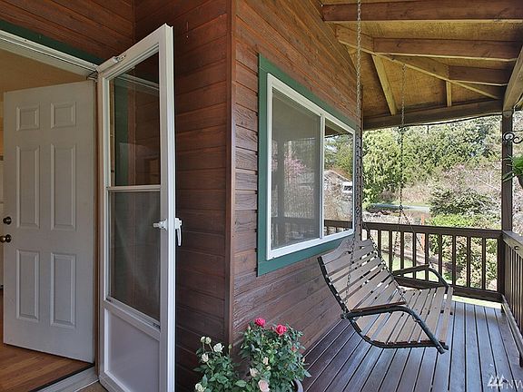 Covered front porch with swing (conveys) provides a dry place to take in the sounds of morning birds or the stillness of summer nights.