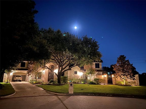 Night view of the front yard showing off all the exterior lighting