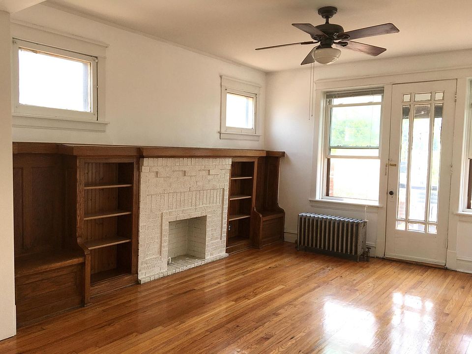 Original oak built in surrounding mid-century modern fireplace. Front porch and back porch and corner unit light.