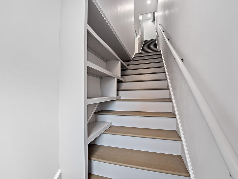 The entry stairwell includes custom shelving perfect for shoes, purses, and more!