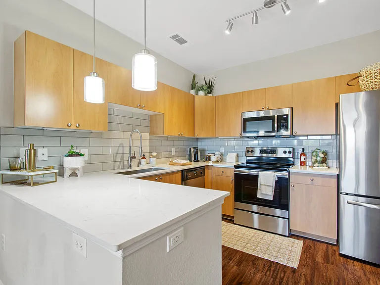 Model Kitchen | Backsplash | Stainless Steel Appliances at Mission Hills Apartments, Texas, 78258