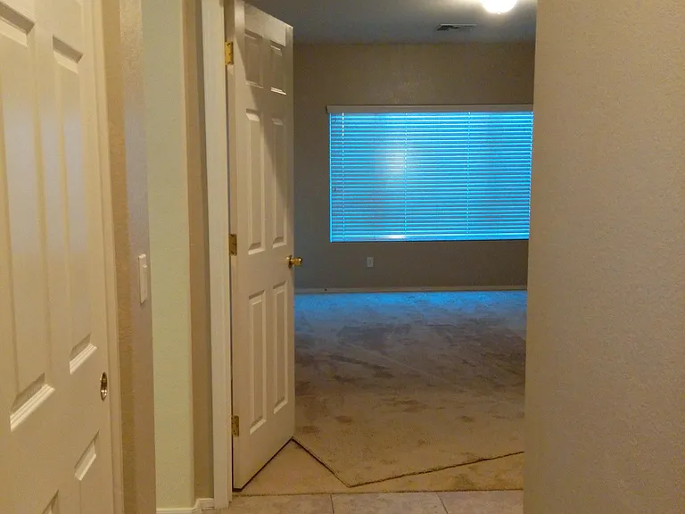 walkway between laundry and master bedroom ,on the left side is entry to kitchen and family room