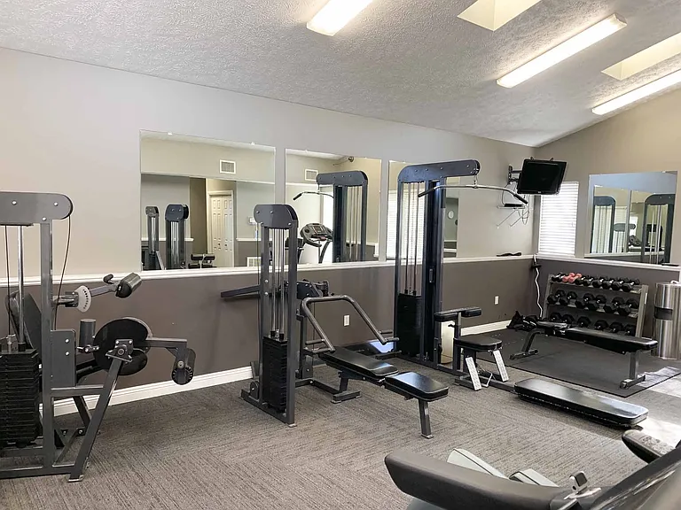 Stay motivated during your workouts with ample space and mirrored walls in our fitness center.