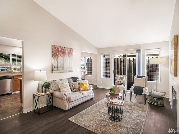 Vaulted ceilings in the living room add a sense of airiness to this luminous space. 