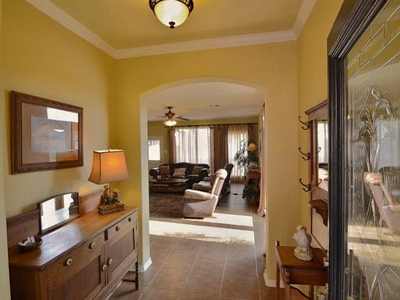 Appealing entry hall with crown molding.....extended tile leads you into the den area