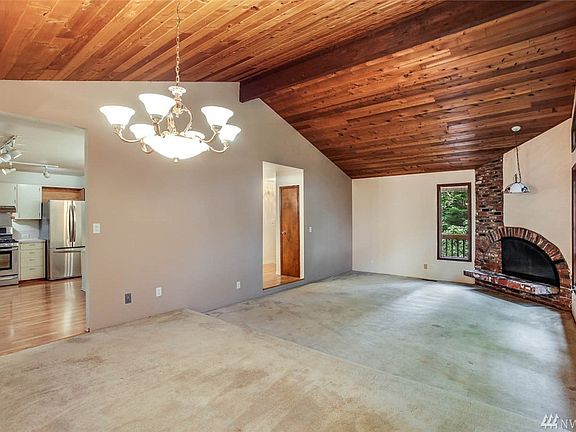 Cozy up to the feature fireplace here. You'll enjoy connecting with guests in the open concept space between the living and dining rooms.