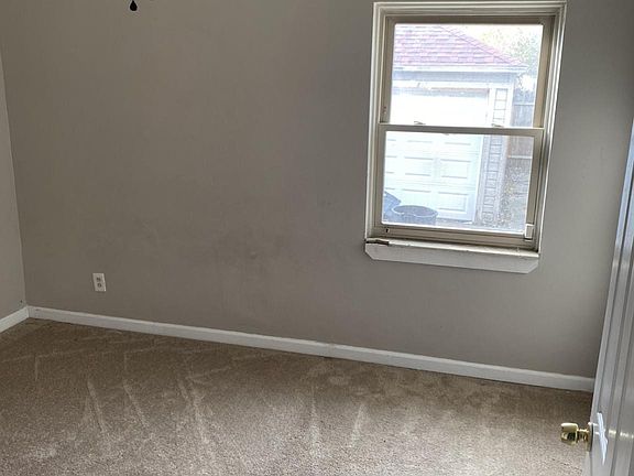 Room downstairs with ceiling fan