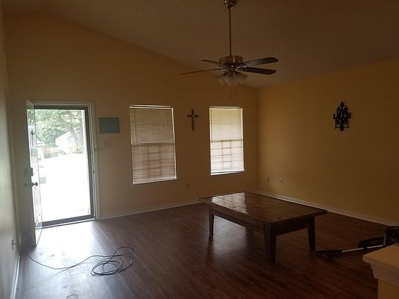 Large living room with a Cathedral ceiling.....opens to sunroom