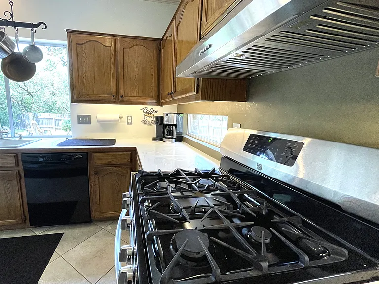 Kitchen features three ovens - this gas range, an electric wall oven and microwave oven.
