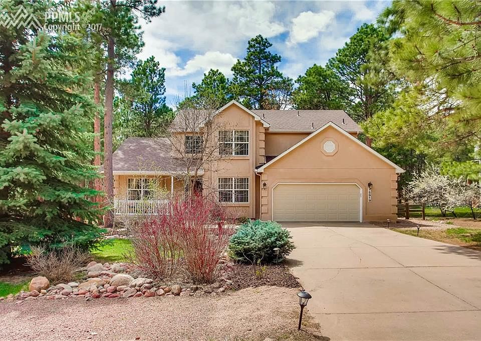 Colorado lifestyle at its best! Stucco 2-story on wooded lot.