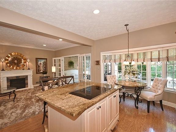 This is a view of the kitchen and breakfast area with its large window providing pleasant views of the outdoor patio and landsca