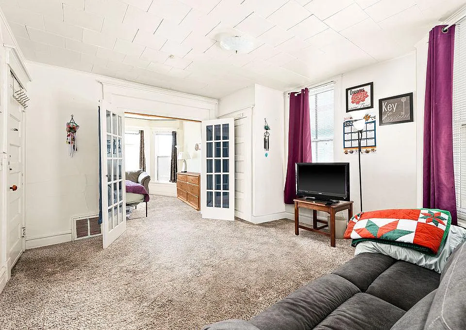 Living room with french doors to the bedroom.