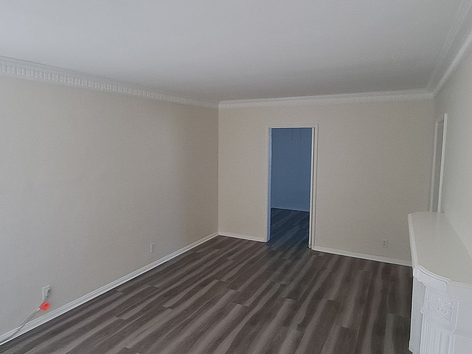 Livingroom view from front doorway. 18'x12' square feet with faux fireplace.