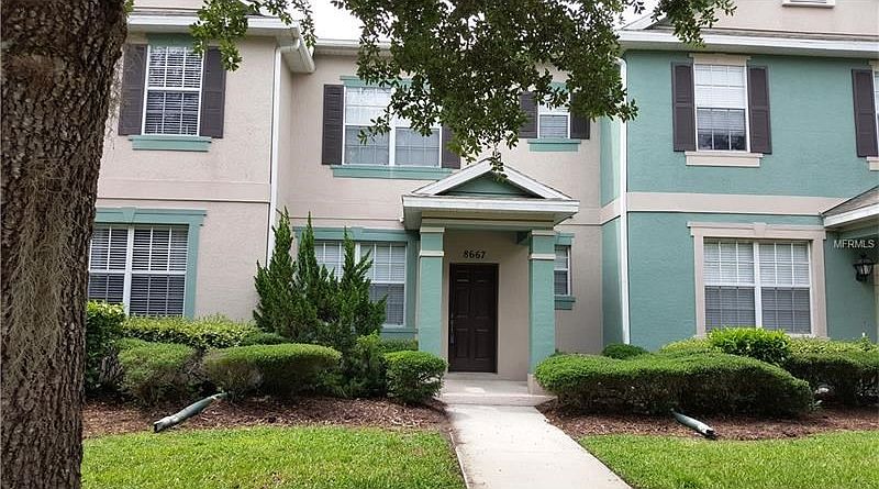 Lush landscaping and canopy trees line the streets of Lake Reams in the Lakes of Windermere