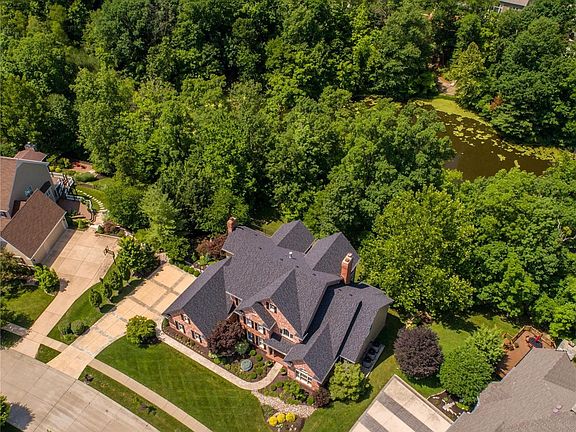 Aerial view of home showing how it backs to the neighborhood lake on the rear side of the property - great views of the lake especially in the winter when trees are bare with no leaves