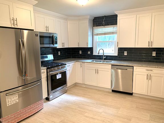 Completely Remodeled Kitchen With New Stainless Steel Appliances and Granite Counters