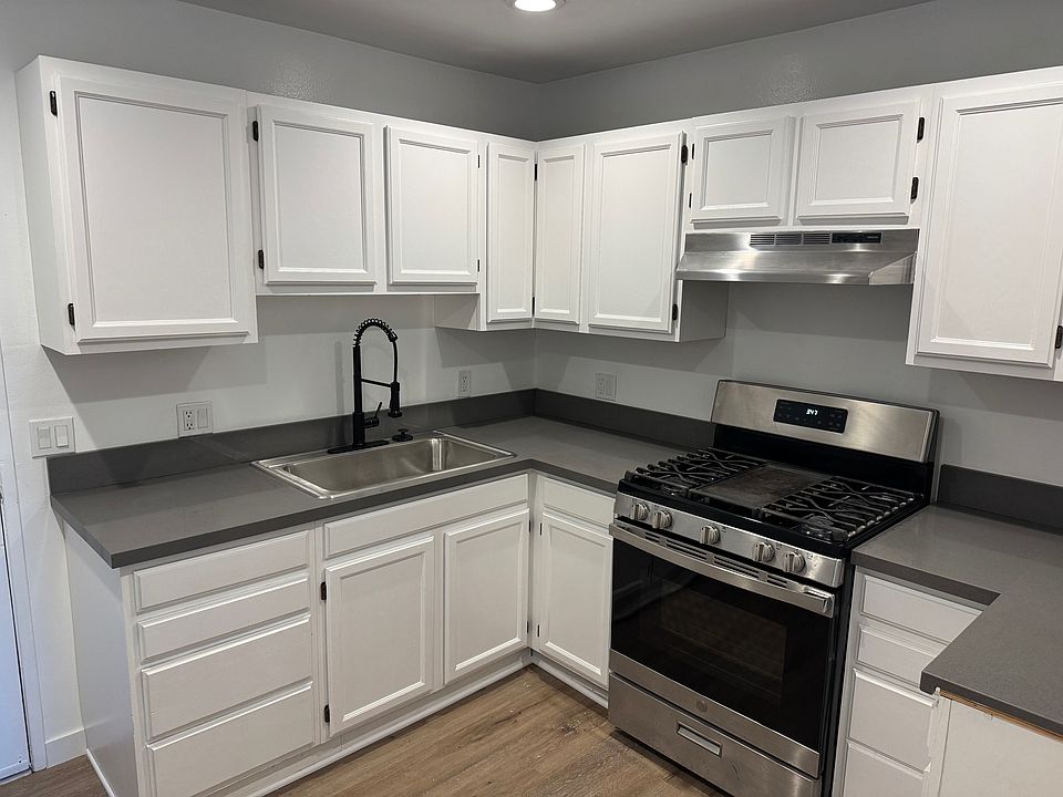 Remodeled kitchen. Quartz counters, large sink, pull down sprayer faucet.