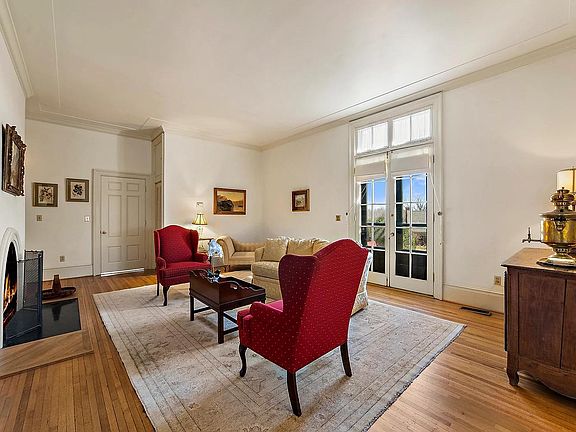 Apartment 2 living room, with doors leading to patio facing south garden. There is a coat closet to the right of the entry door.