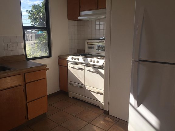 Kitchen w/ new refrigerator + O'Keefe and Merritt Range
