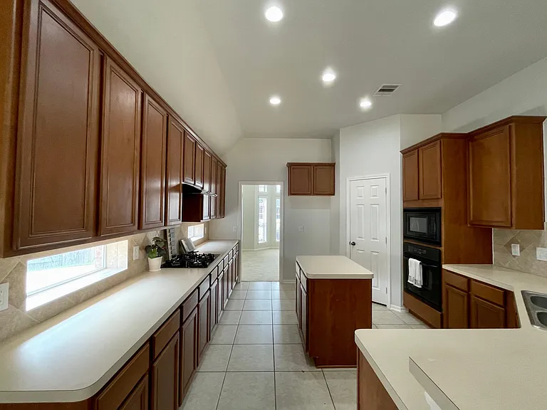 Open layout allows the kitchen to flow seamlessly into both family room and formal dining room.