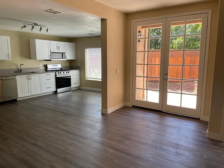 Kitchen , living area and entrance to private backyard