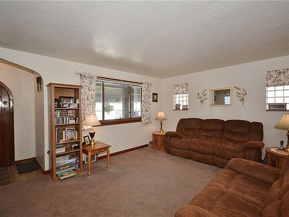 Lots of natural light floods the living room from the large front window and glass block side windows.