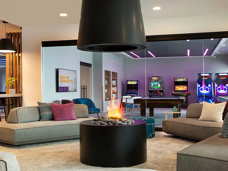 __ Lobby view with game room
__ Enjoy a glimpse of the vibrant game room from the lobby, where fun and relaxation meet. Perfect for unwinding with friends or challenging yourself to a game after a day of adventure.