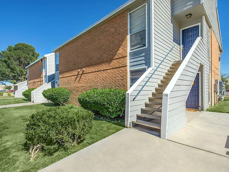 Wind Tree Apartments Exterior with Stairs and Landscape in El Paso, TX