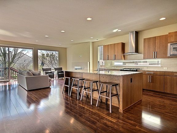 Floor-to-ceiling windows throughout the living, dining room and kitchen provide a light modern feel