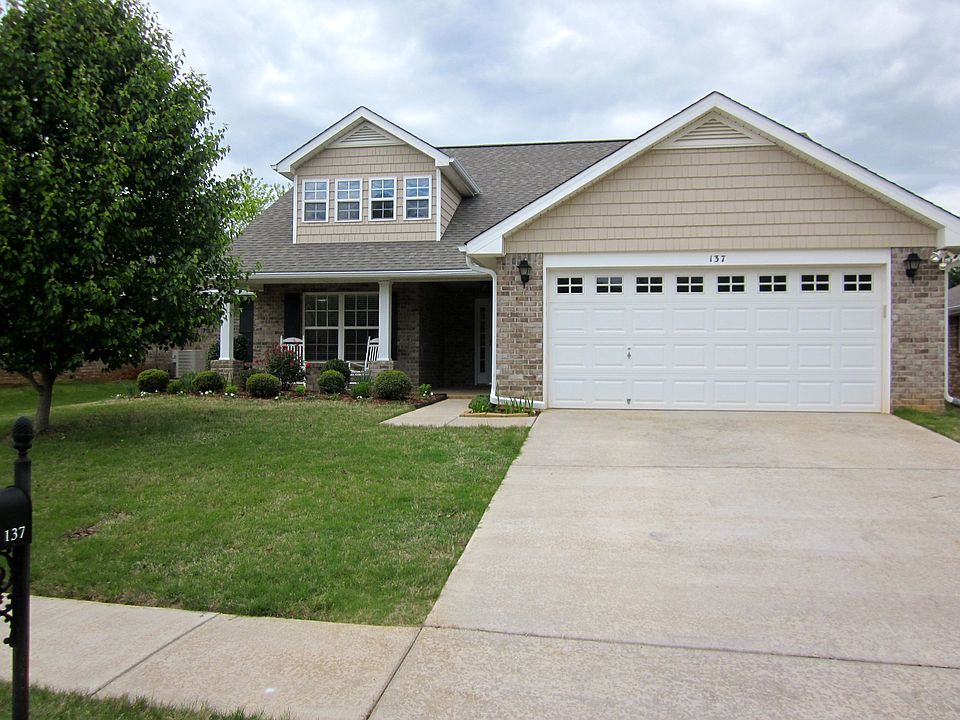 Brick Home-Beautiful landscaping, security lights, floored attic space.