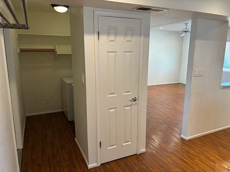 Garage door right off laundry area and view from kitchen into living room.