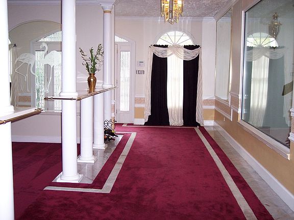 Between Foyer, Formal Living Room, 1st Atrium and Formal Dining Room.