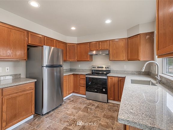 The well-appointed kitchen has beeen tastefully updated with new quartz counters, new stainless appliances, and an undermount stainless sink.