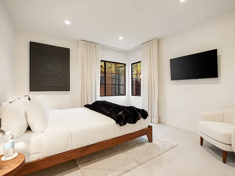 Every element, from the tailored bedding to the soft pendant glow, is designed for relaxation.