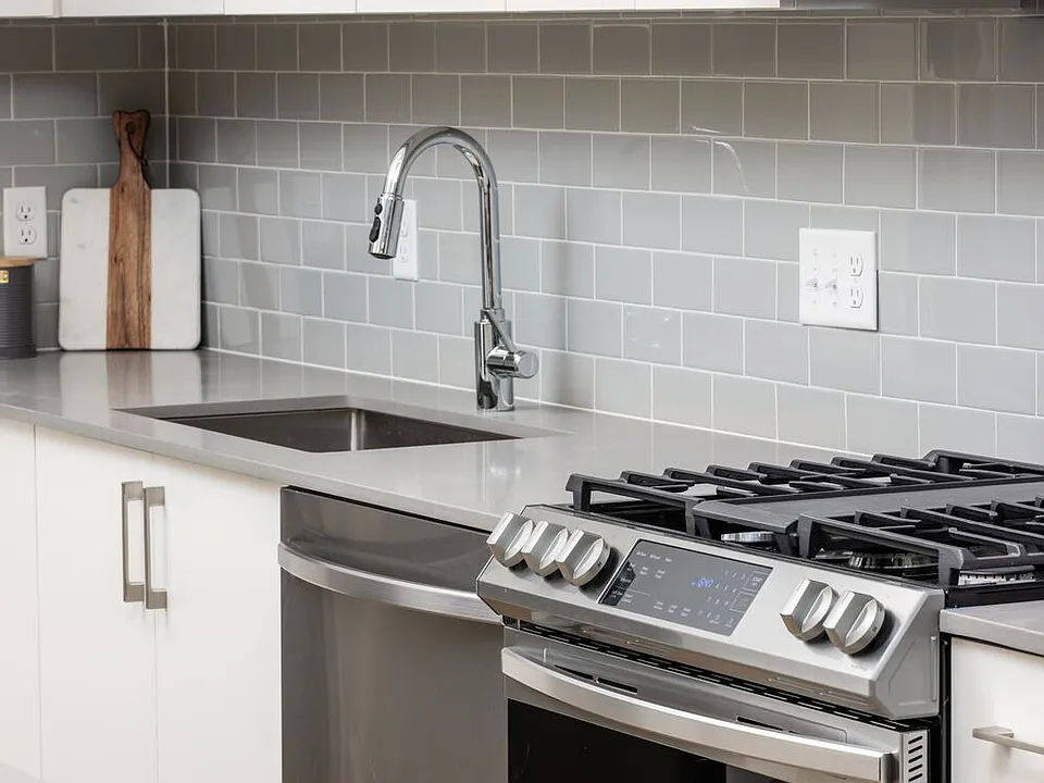 Grey tile backsplash and grey quartz countertops