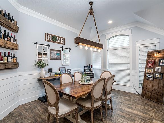 Formal Dining Room: Shiplap wainscoting, beautiful moldings, and a barn beam light create this elegant space perfect for entertaining.