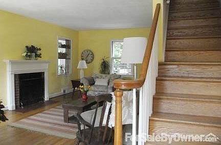 Front entrance into living room, featuring center stairs.
