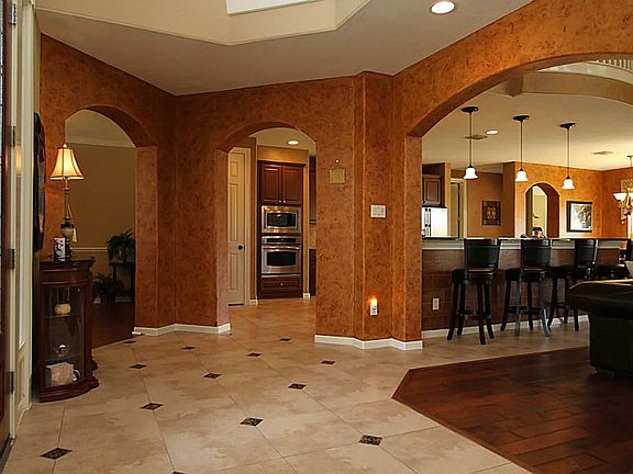 THE BEAUTY OF THIS HOME IS SEEN IMMEDIATELY UPON ENTERING. THE GRAND FOYER IS ADORNED WITH CUSTOM DESIGNED FLOORING AND INVITING COLORS.