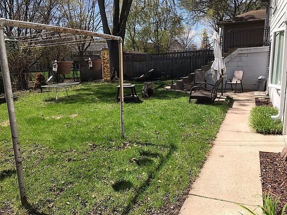 Back sidewalk to lower level entry door.