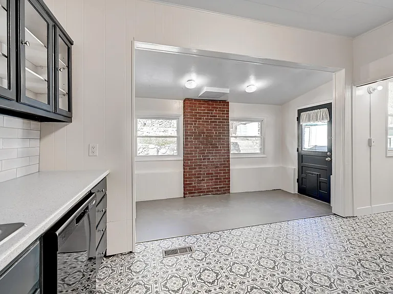 Exposed brick adds a focal point to the kitchen/laundry area!